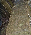 simple Christian Pictish cross embedded in kirkyard wall